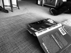 a black and white photo of a book turned upside down on the base of my couch