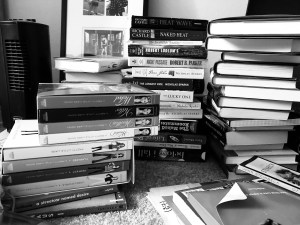 a black and white photo of piles and piles of books