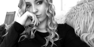 a black and white selfie, I'm wearing a black shirt, my blonde hair is nicely curled and my makeup is done