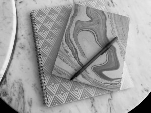 a black and white photo of my notebooks on my coffee table