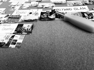 A black and white close up of the edge of my bulletin board, where I've started removing all of my design inspo photographs