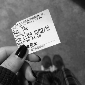a black and white photo of me holding a ticket stub to see The Nun in theaters 