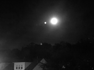 a black and white photo of the full moon at night, very blurry 