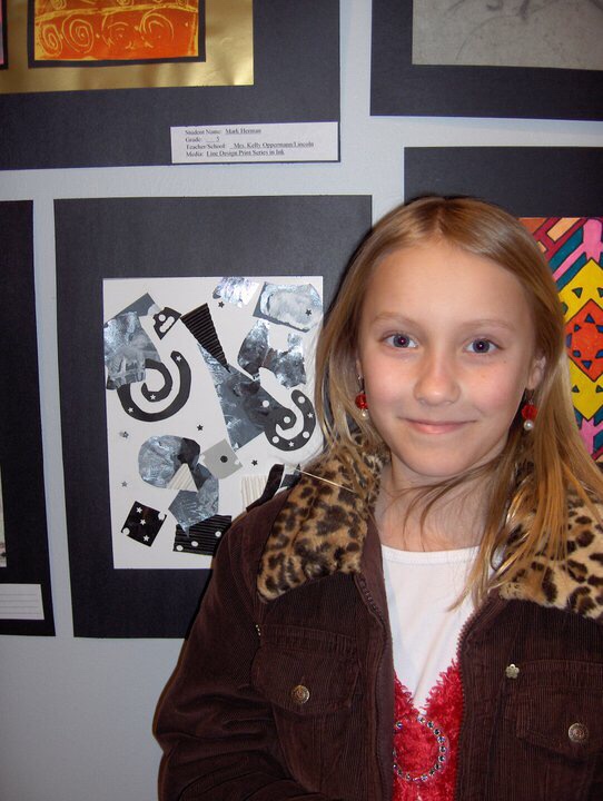 a photo of me when I was little standing in front of some metallic abstract art I created and was having showcased