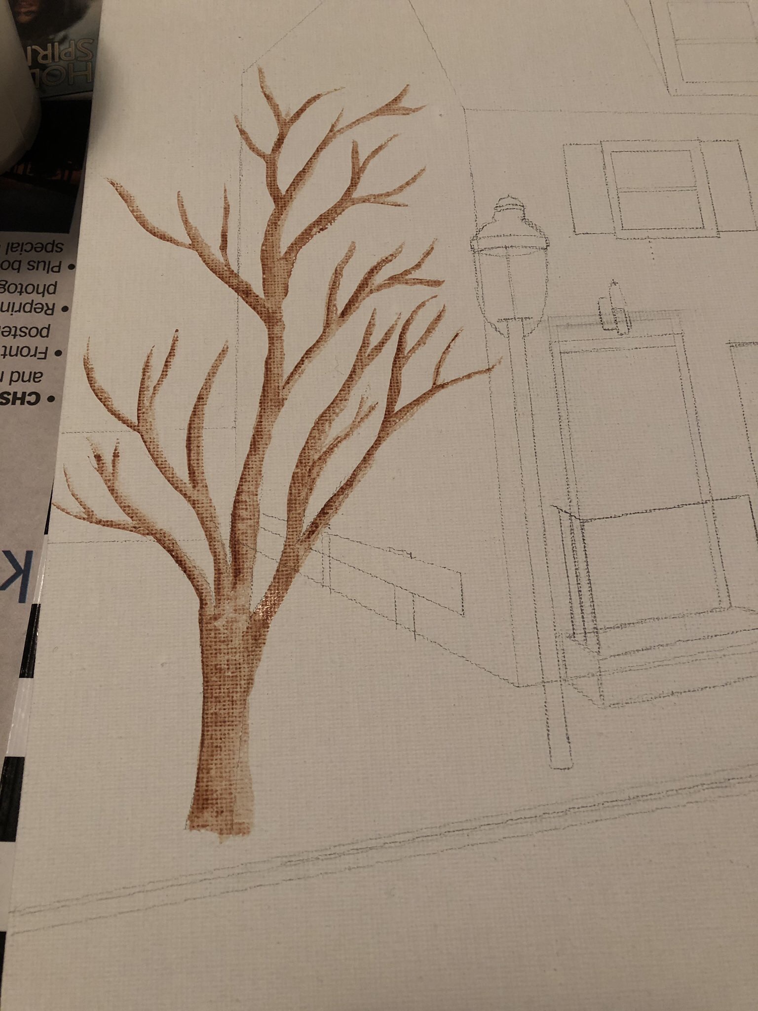 process of a painting, stage one the house on the right is outlined in pencil and the tree has been painted with a brown trunk