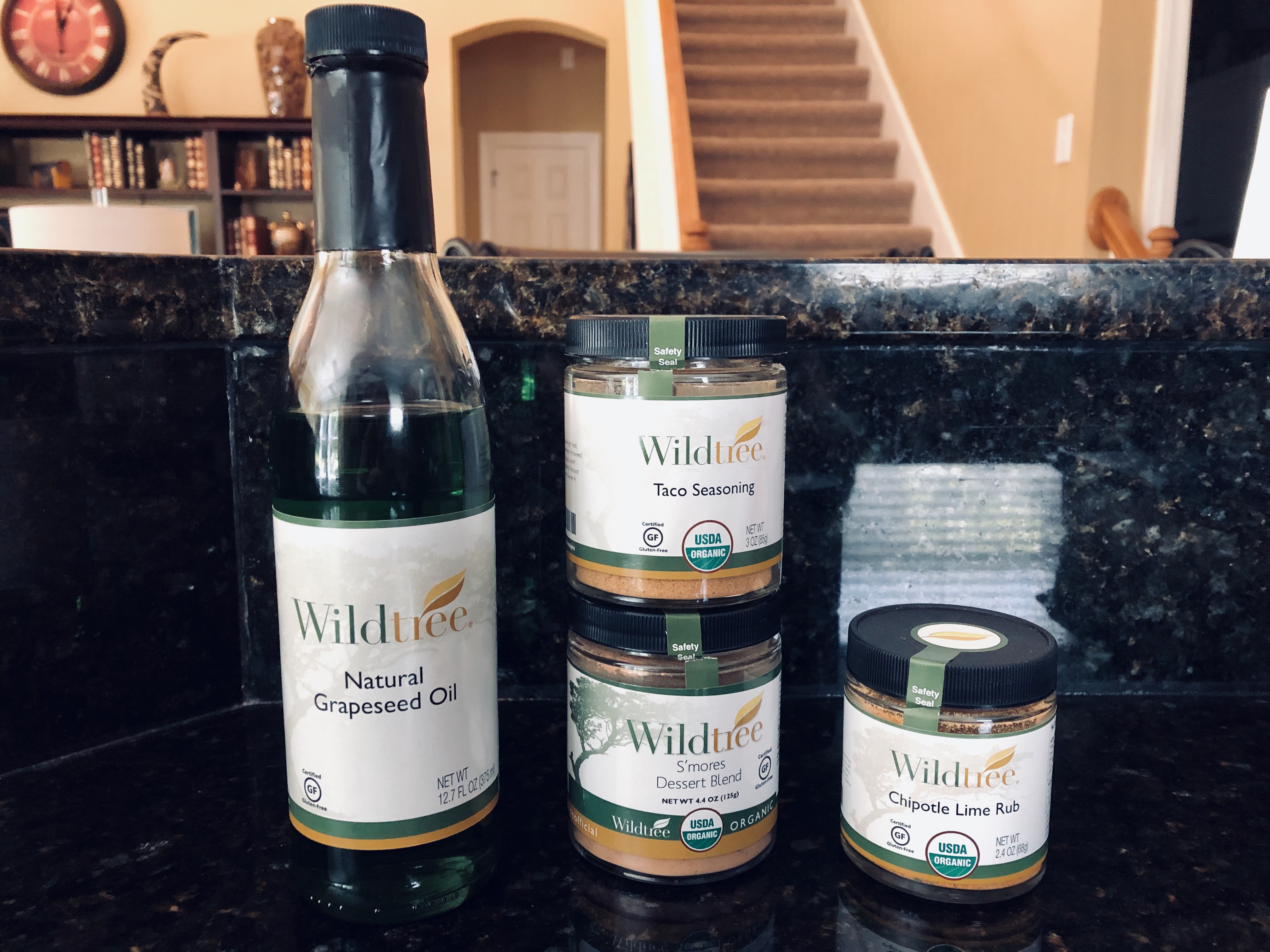 an array of wildtree branded products including grapeseed oil, taco seasoing, smore's dessert blend and a chipotle lime rub