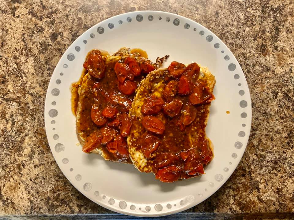French toast topped with cherry tomatoes and a balsamic glaze. 