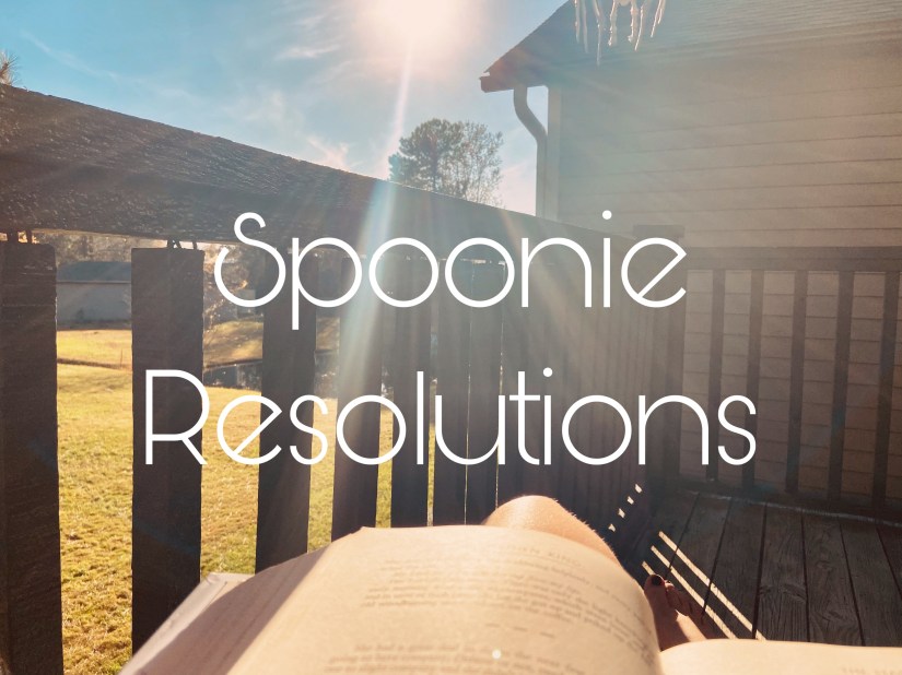 image text: spoonie resolutions
image background: looking down on a book with the sun shining down overlooking a small pond and some trees through a wooden balcony.