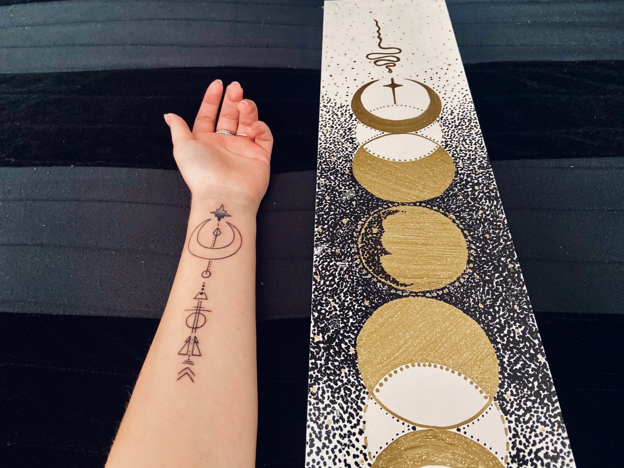 side by side of new tattoo - crescent moon with an arrow - and my moon phases painting