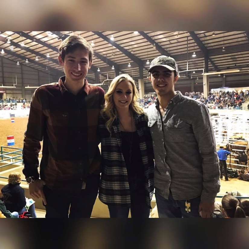 Girl in a flannel shirt with two gentlemen at a rodeo. 