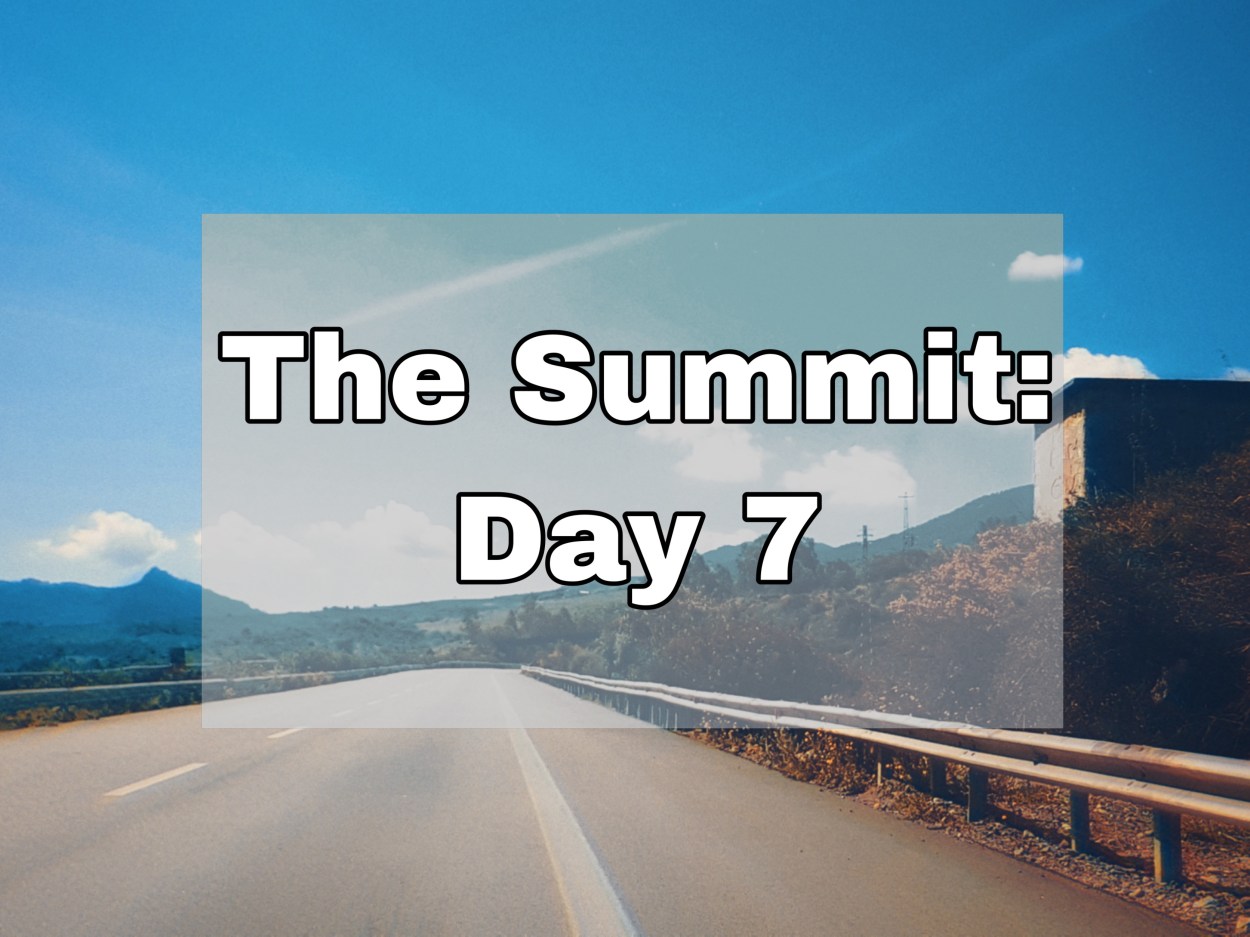 An empty road leading towards the mountains in the distance. Text overlay "The Summit: Day 7"