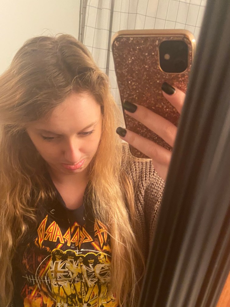 A photo looking downward onto my roots. The top 3 inches of my hair is a light brown color and then my regular blonde hair grows beyond that. I'm making a sad face in the photo. 
